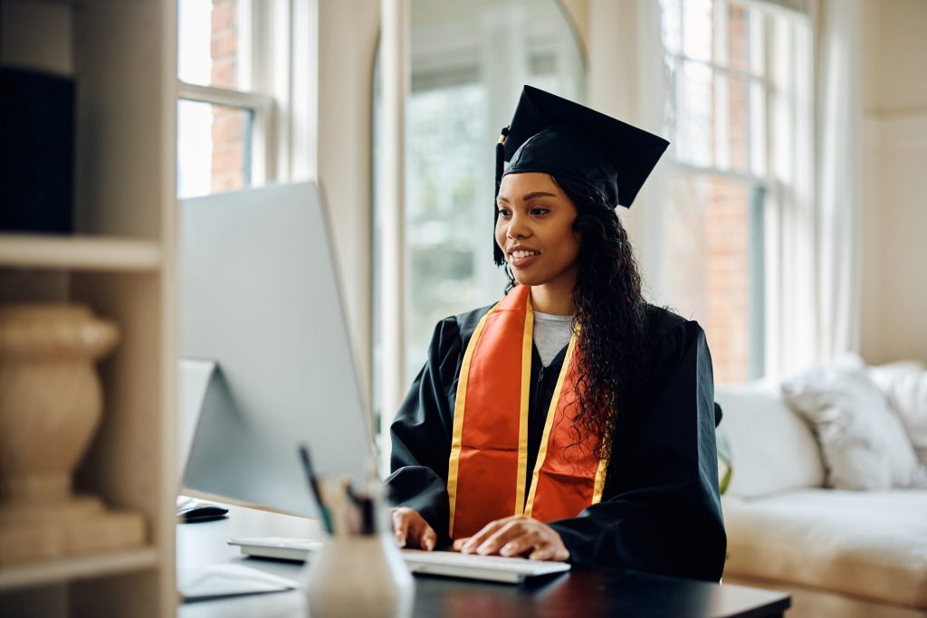 Graduate ordering her Transcript when applying to graduate school on a laptop.